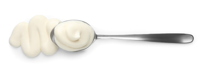 Photo of Tasty mayonnaise sauce and spoon isolated on white, top view