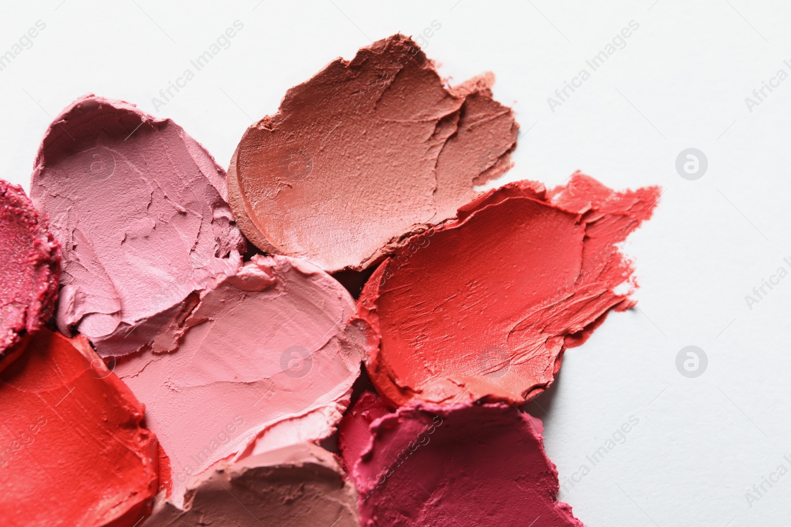 Photo of Collection of lipstick swatches on white background, top view