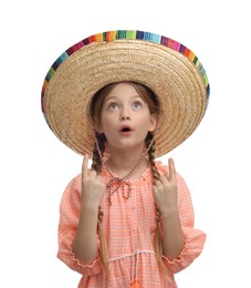 Photo of Emotional girl in Mexican sombrero hat pointing at something on white background