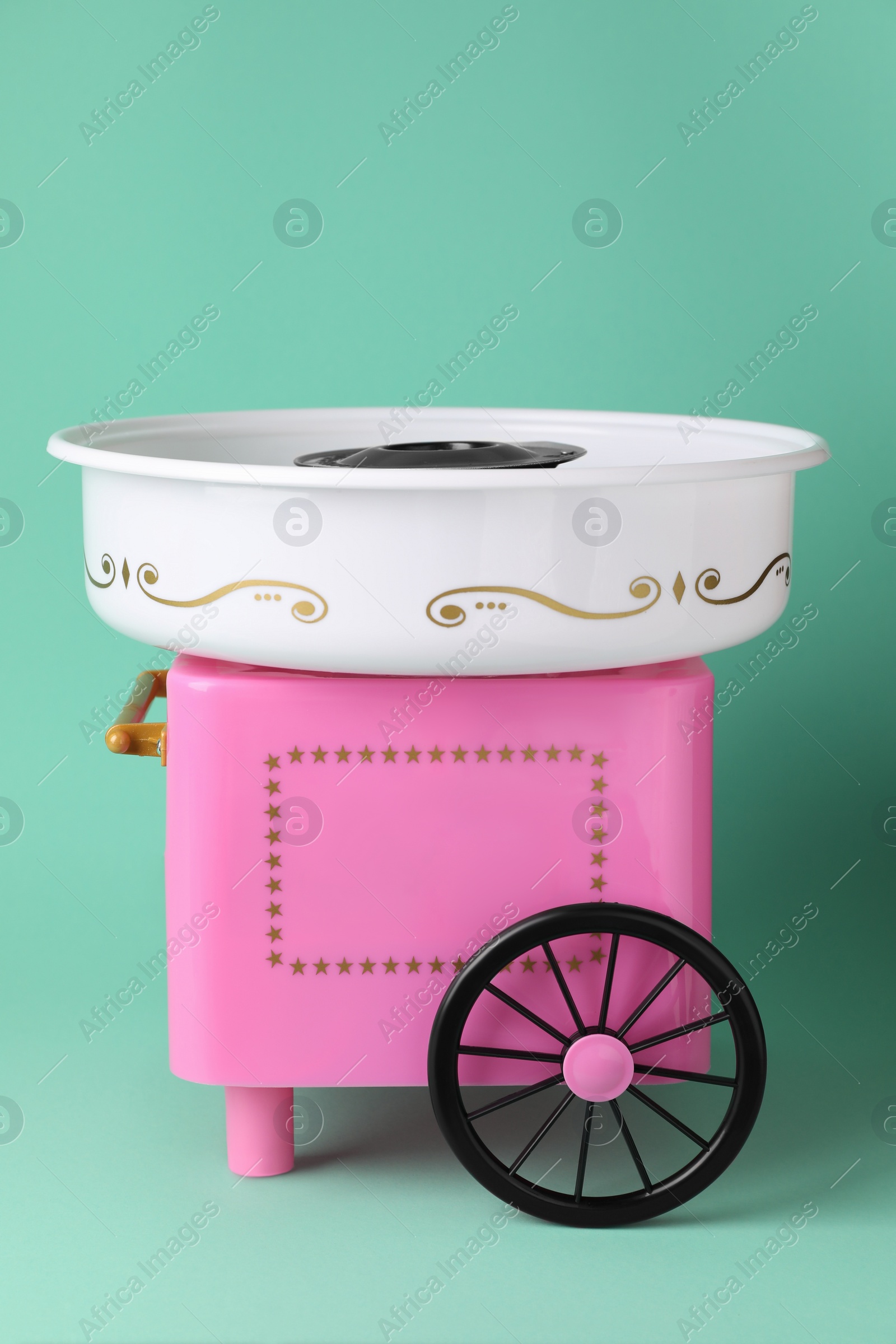 Photo of Portable candy cotton machine on turquoise background