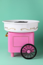 Photo of Portable candy cotton machine on turquoise background