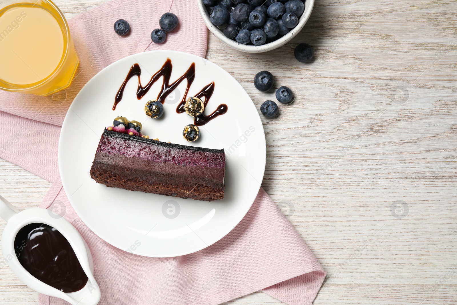 Photo of Delicious cake with blueberry on white wooden table, flat lay. Space for text