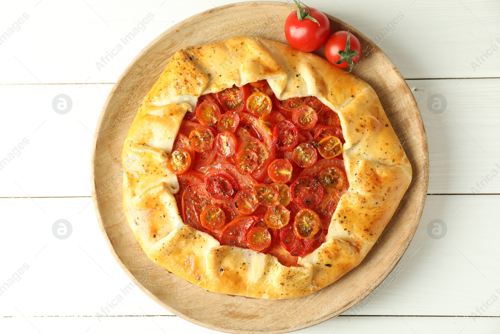 Photo of Tasty tomato galette (Caprese galette) on white wooden table, top view