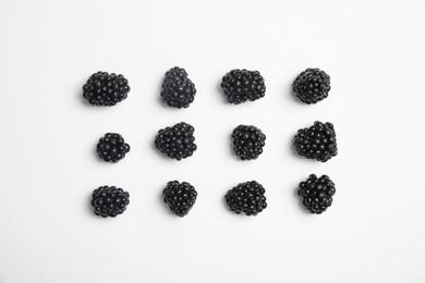 Flat lay composition with ripe blackberries on white background