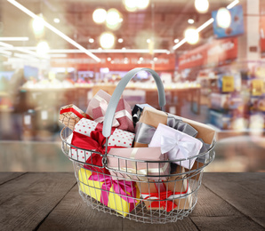 Image of Boxing day concept. Shopping basket with gifts in supermarket