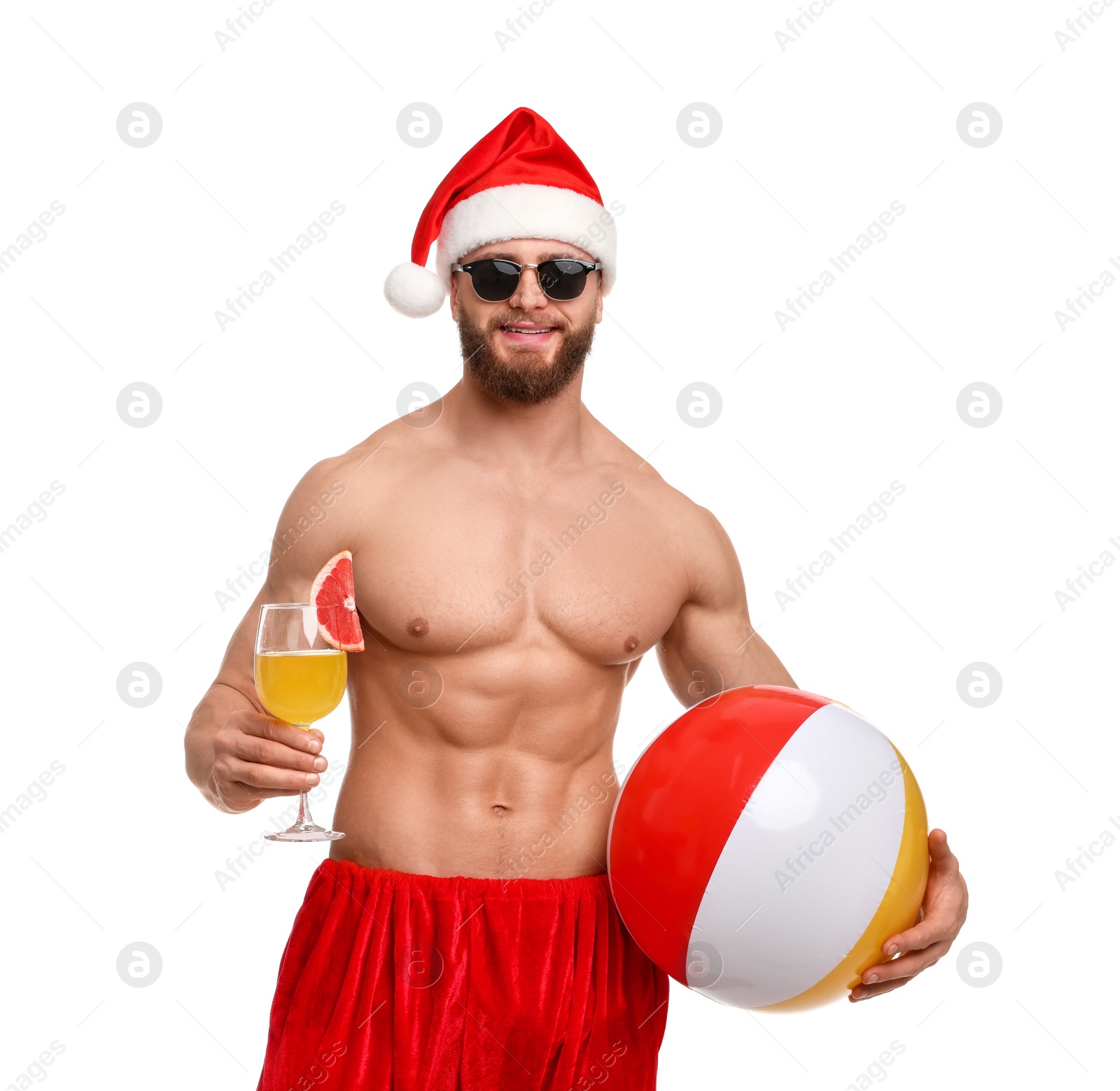 Photo of Muscular young man in Santa hat with ball and cocktail on white background
