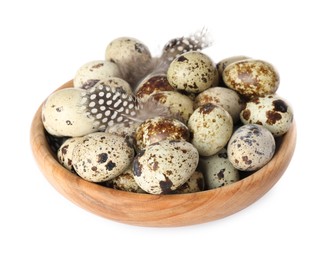 Bowl with speckled quail eggs and feathers isolated on white