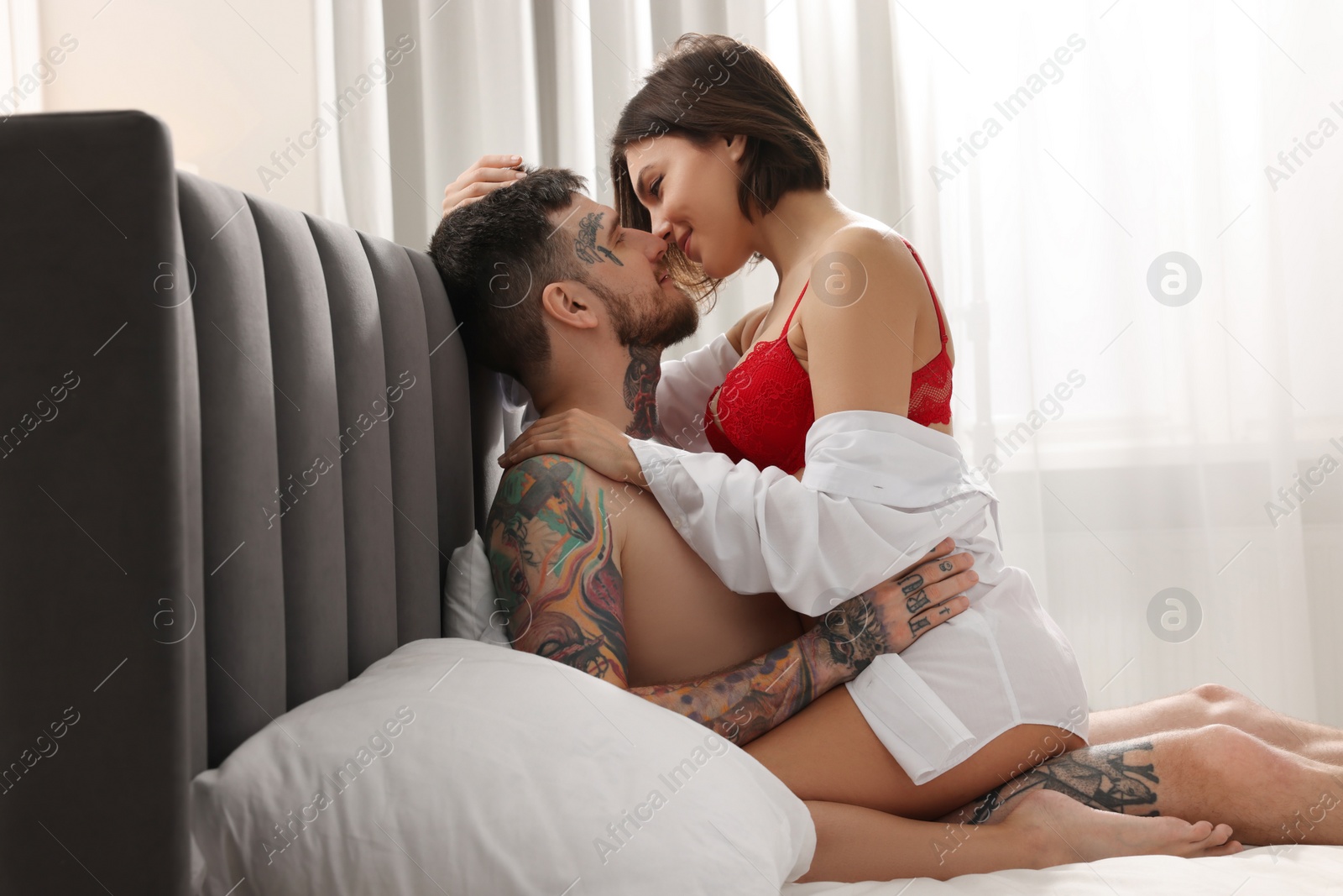 Photo of Passionate couple having sex on bed at home