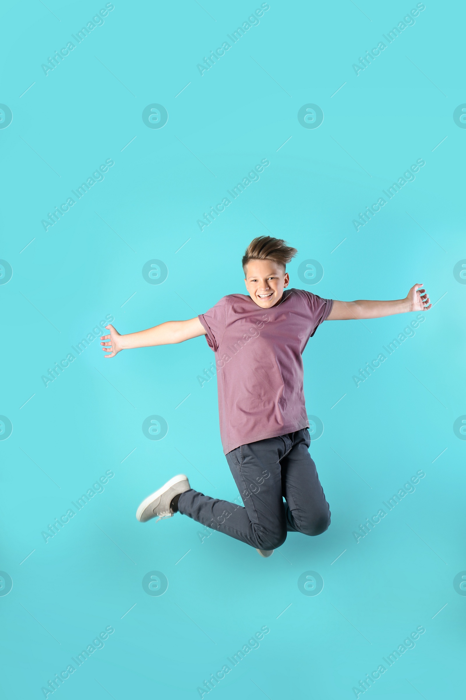 Photo of Teenage boy in casual clothes on color background