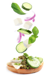 Image of Tasty bruschetta with flying ingredients on white background