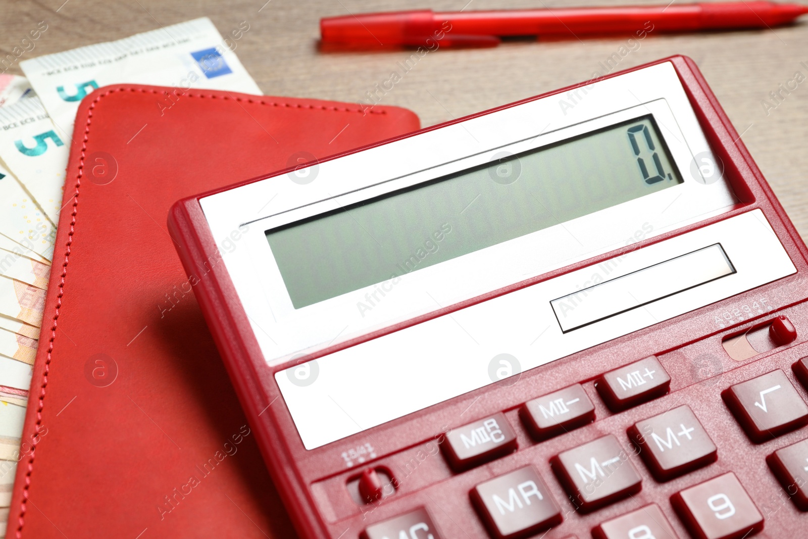 Photo of Calculator, notebook and money on wooden table, closeup. Tax accounting