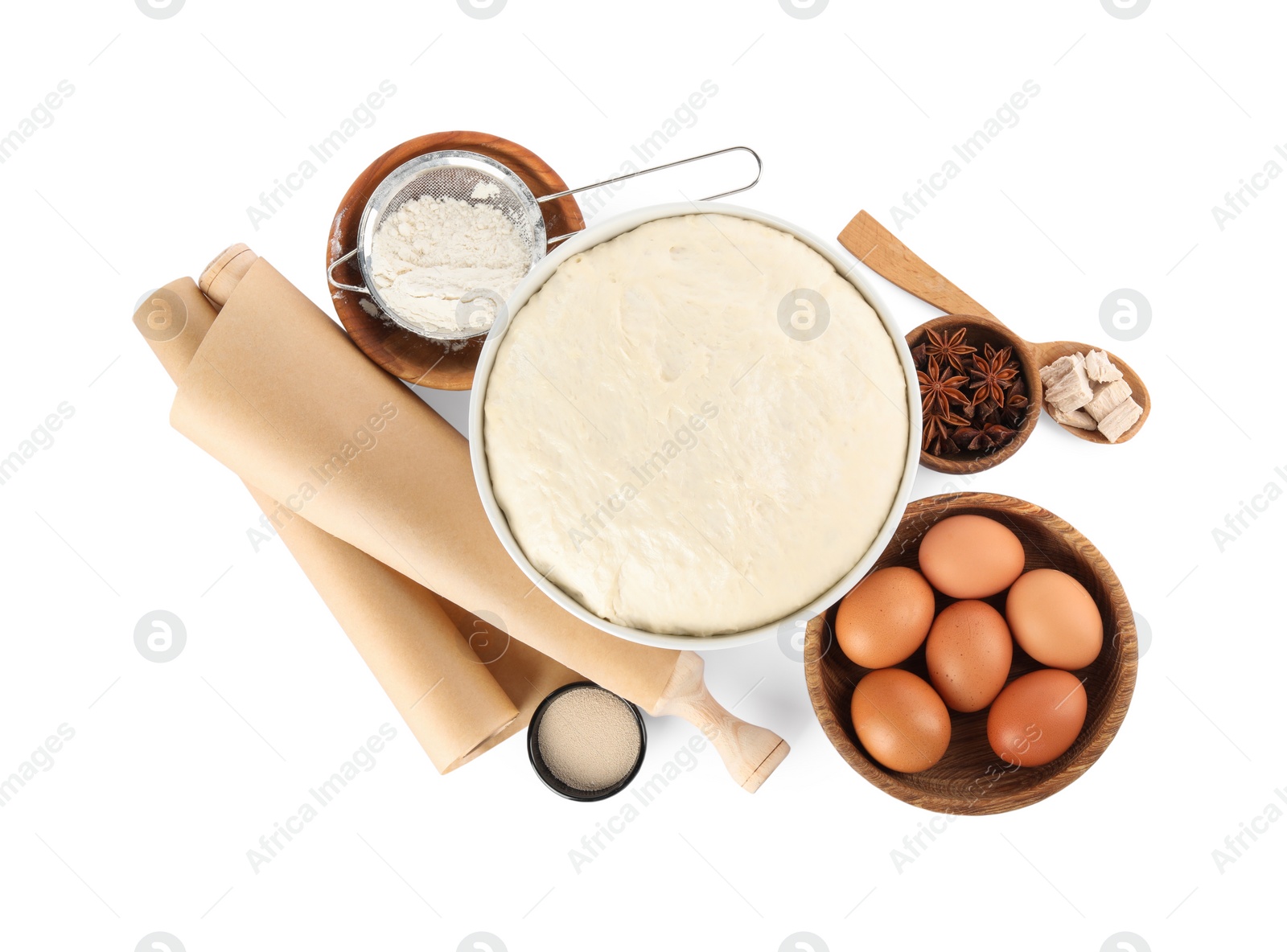 Photo of Composition with fresh yeast dough, parchment paper and ingredients on white background, top view. Making cake