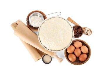 Photo of Composition with fresh yeast dough, parchment paper and ingredients on white background, top view. Making cake