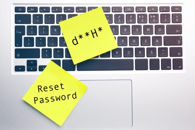 Image of Sticky notes with phrase Reset Password and posscode on laptop, top view