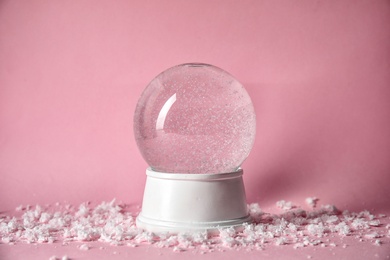 Photo of Magical empty snow globe on color background