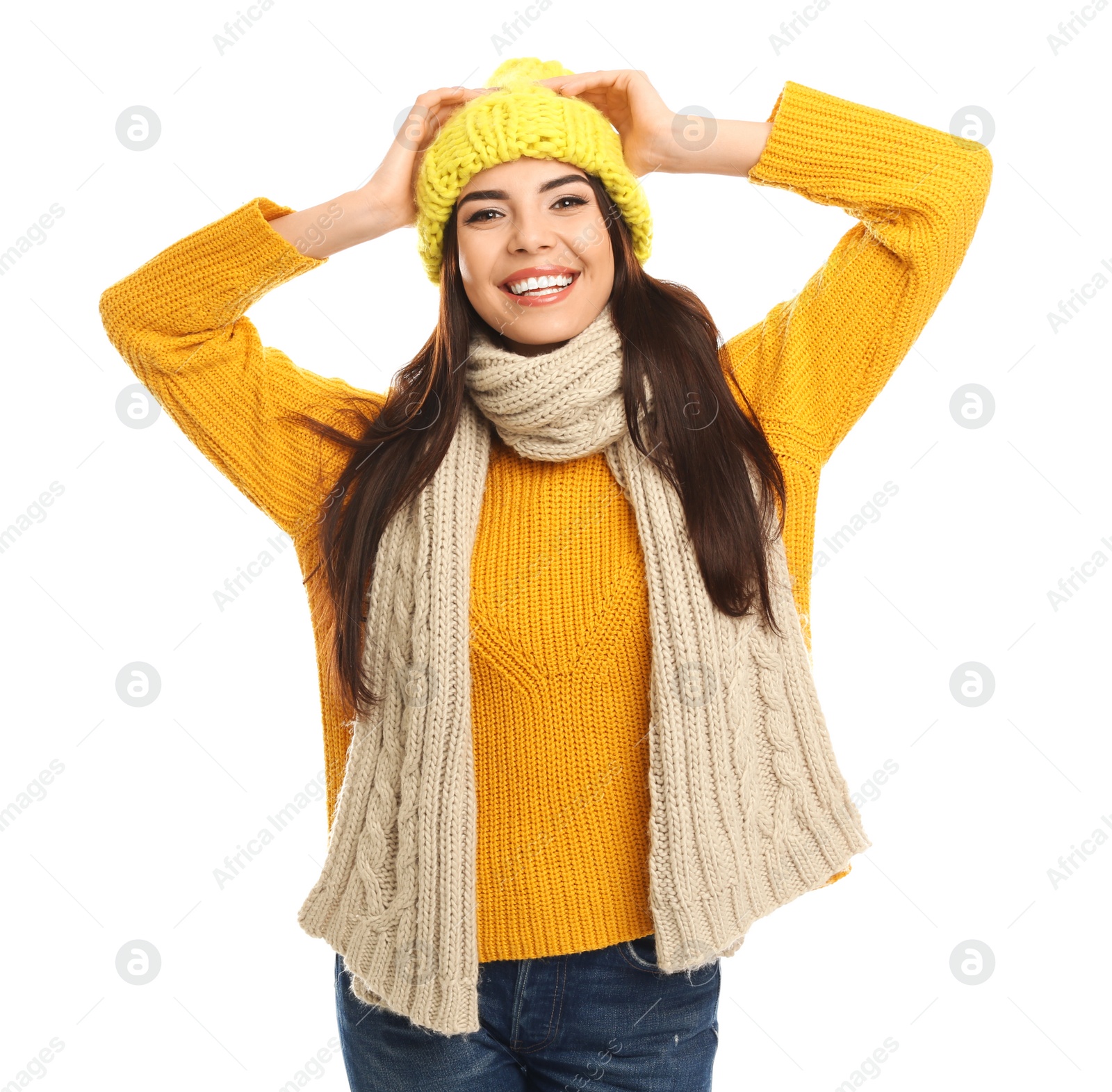 Photo of Happy young woman in warm clothes on white background. Winter vacation