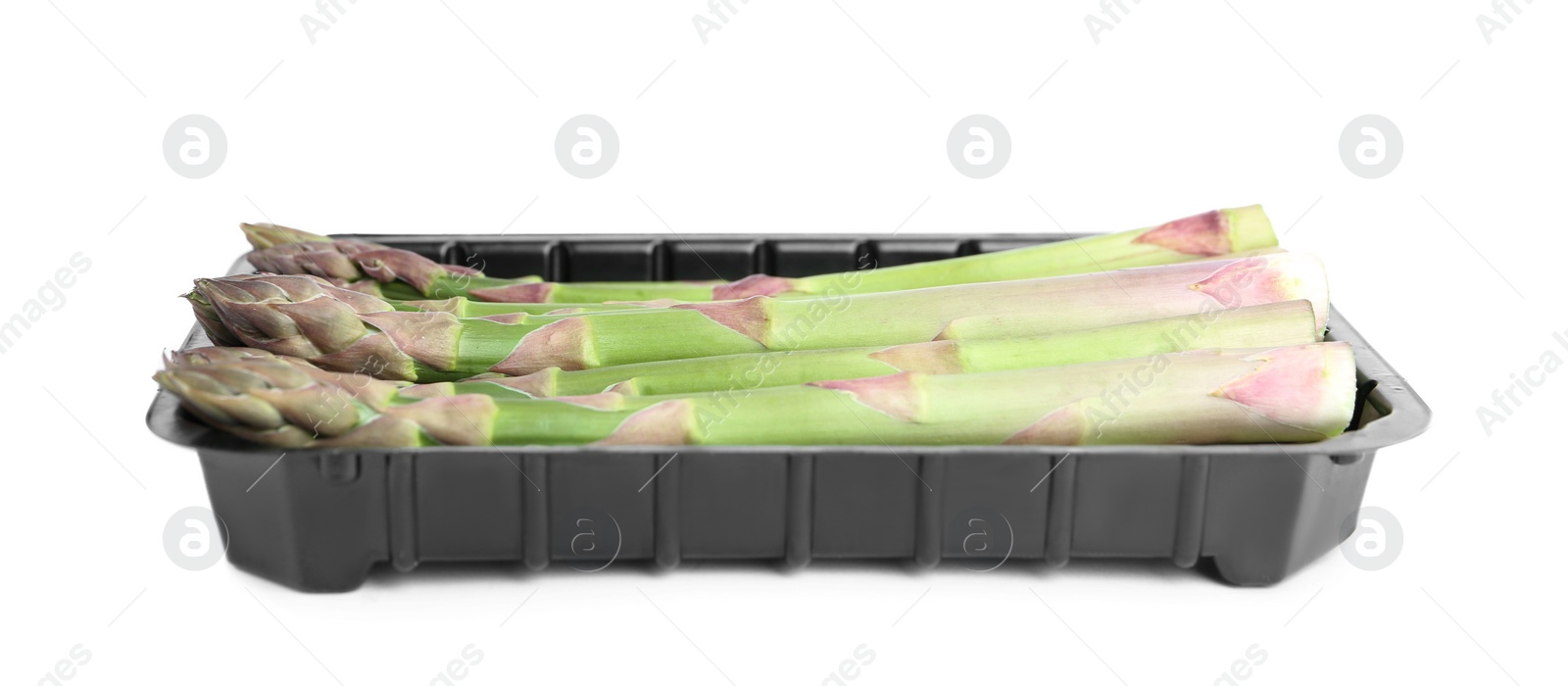 Photo of Fresh raw asparagus in plastic container isolated on white