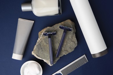 Photo of Flat lay composition with shaving accessories for men on blue background