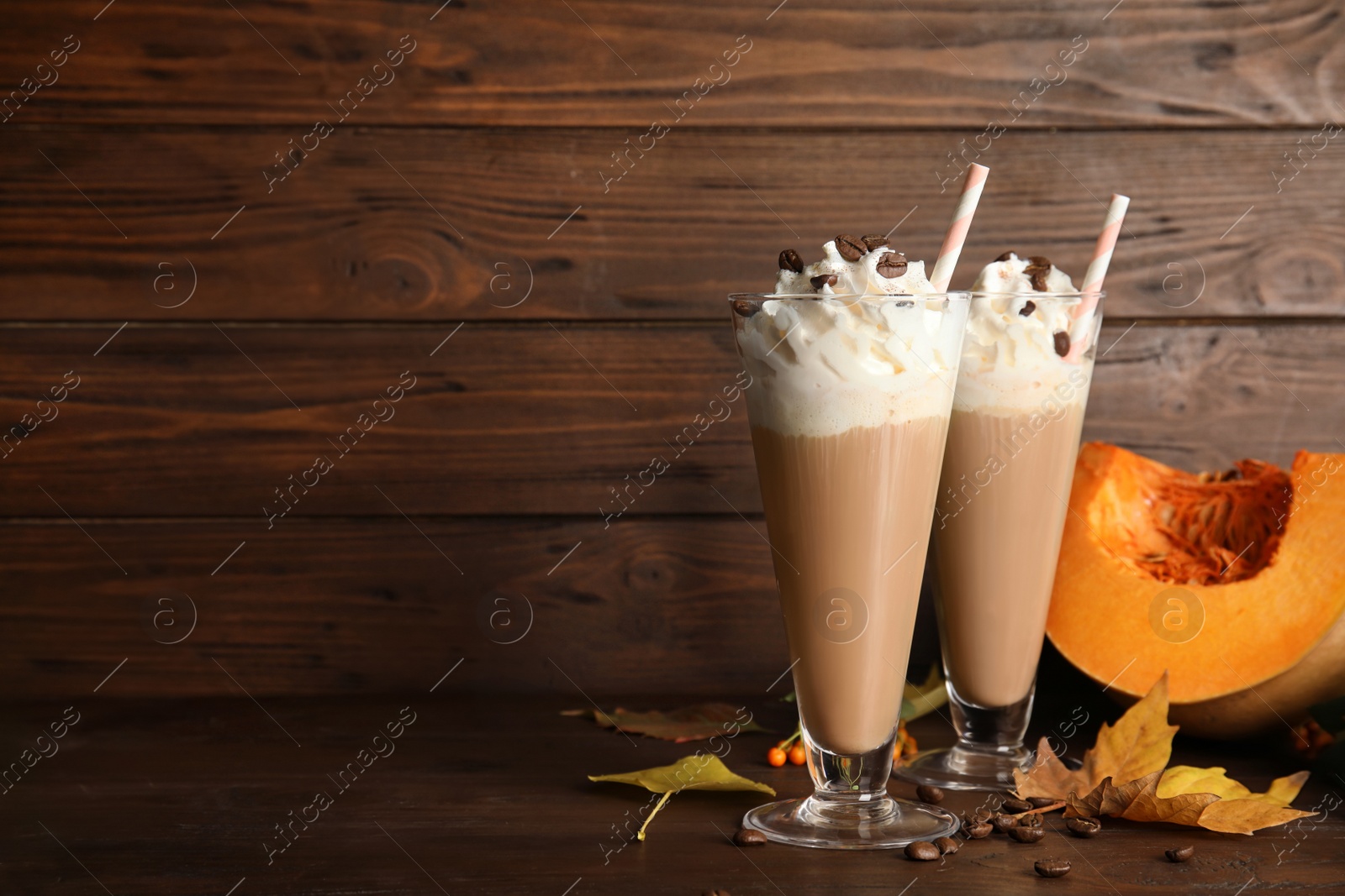 Photo of Composition with tasty pumpkin spice latte on table. Space for text