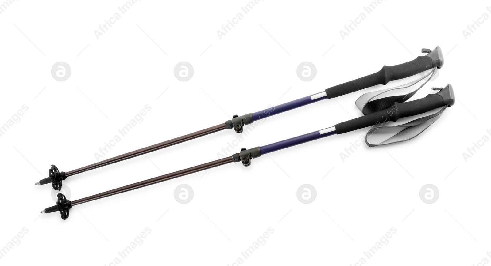 Photo of Pair of trekking poles on white background, top view. Camping tourism