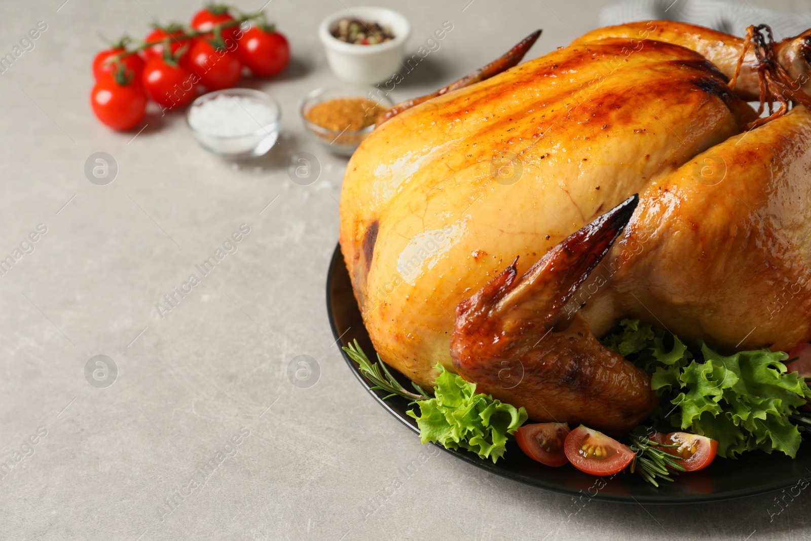 Photo of Platter of cooked turkey with garnish on table, closeup. Space for text