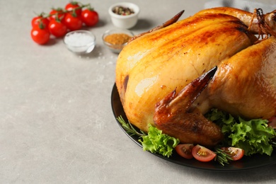 Photo of Platter of cooked turkey with garnish on table, closeup. Space for text