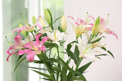 Bouquet of beautiful lilies on blurred background