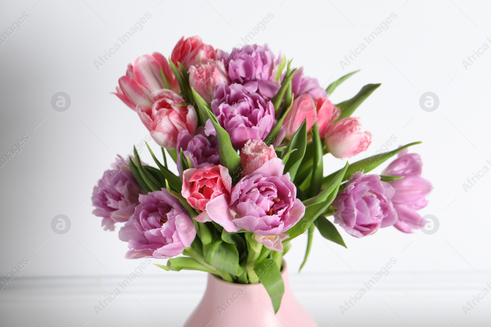 Photo of Beautiful bouquet of colorful tulip flowers on white background, closeup