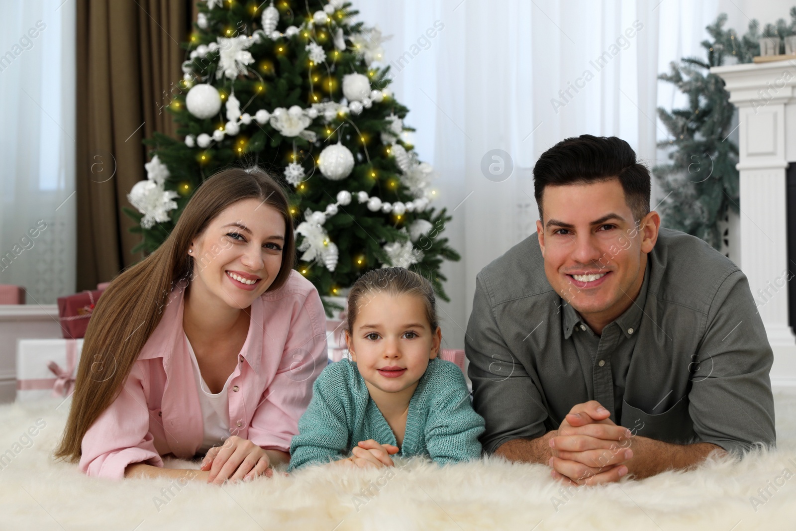 Photo of Happy family in room decorated for Christmas