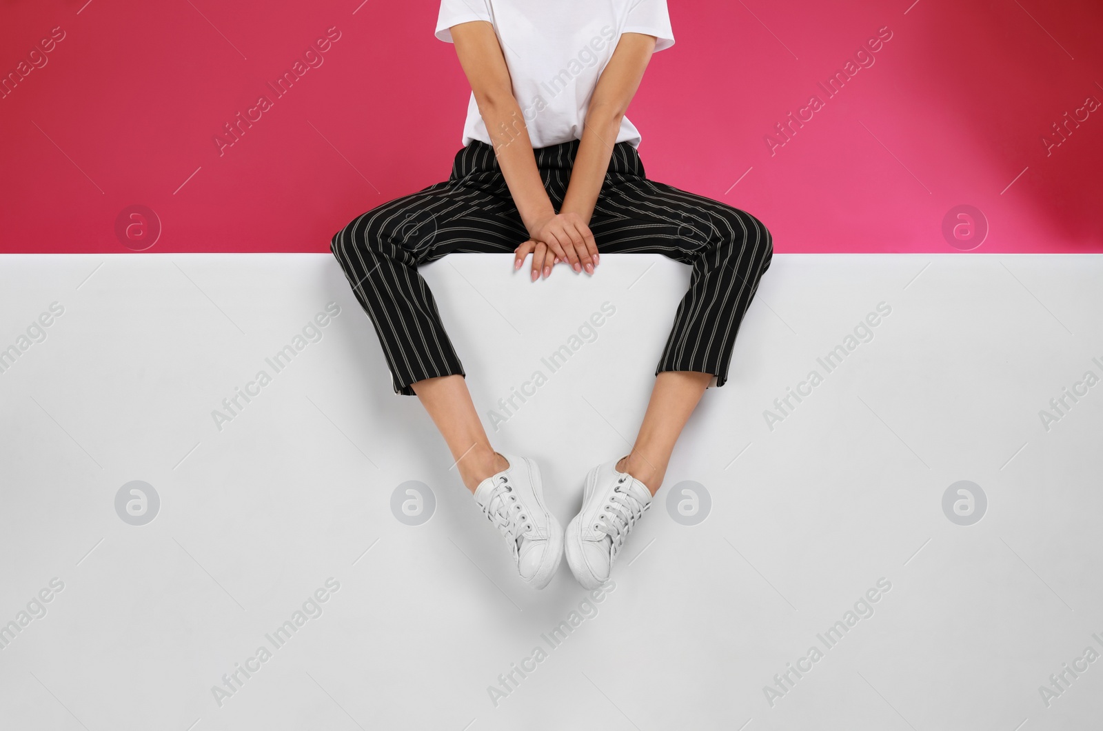 Photo of Woman wearing stylish shoes on color background, closeup