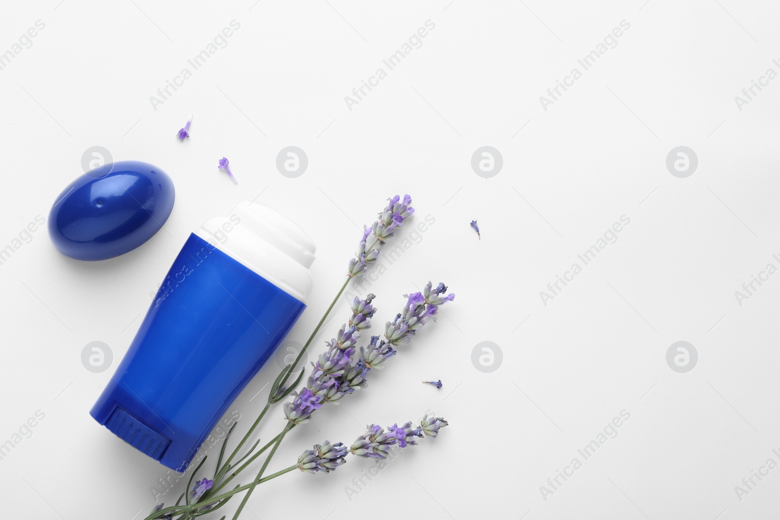 Photo of Female deodorant and lavender flowers on white background, top view