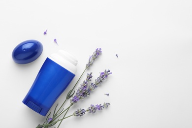 Photo of Female deodorant and lavender flowers on white background, top view