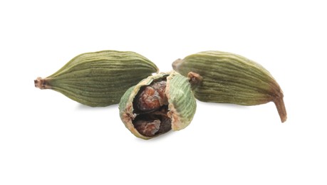 Photo of Dry green cardamom pods on white background, closeup