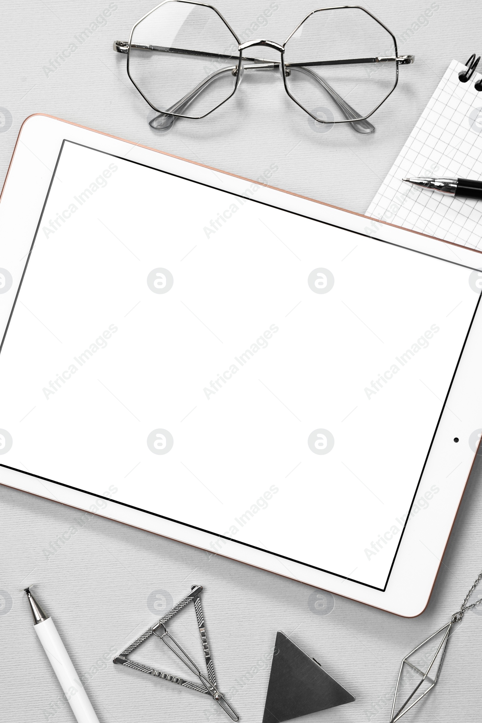 Photo of Flat lay composition with modern tablet on light grey background. Space for text