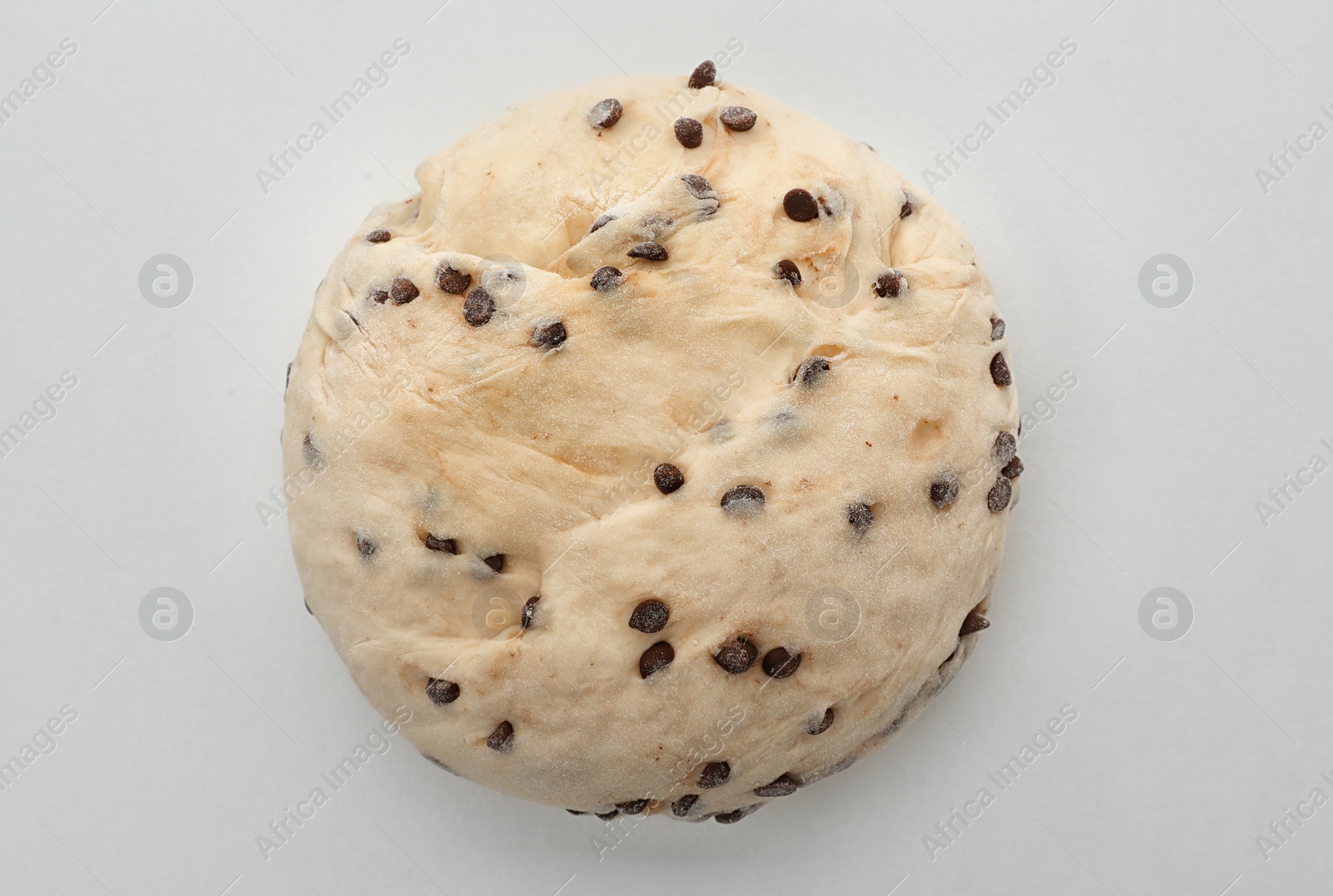 Photo of Raw wheat dough with chocolate chips on white background, top view