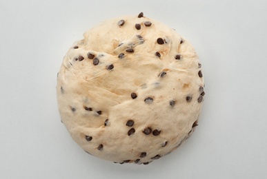 Photo of Raw wheat dough with chocolate chips on white background, top view
