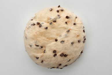 Raw wheat dough with chocolate chips on white background, top view