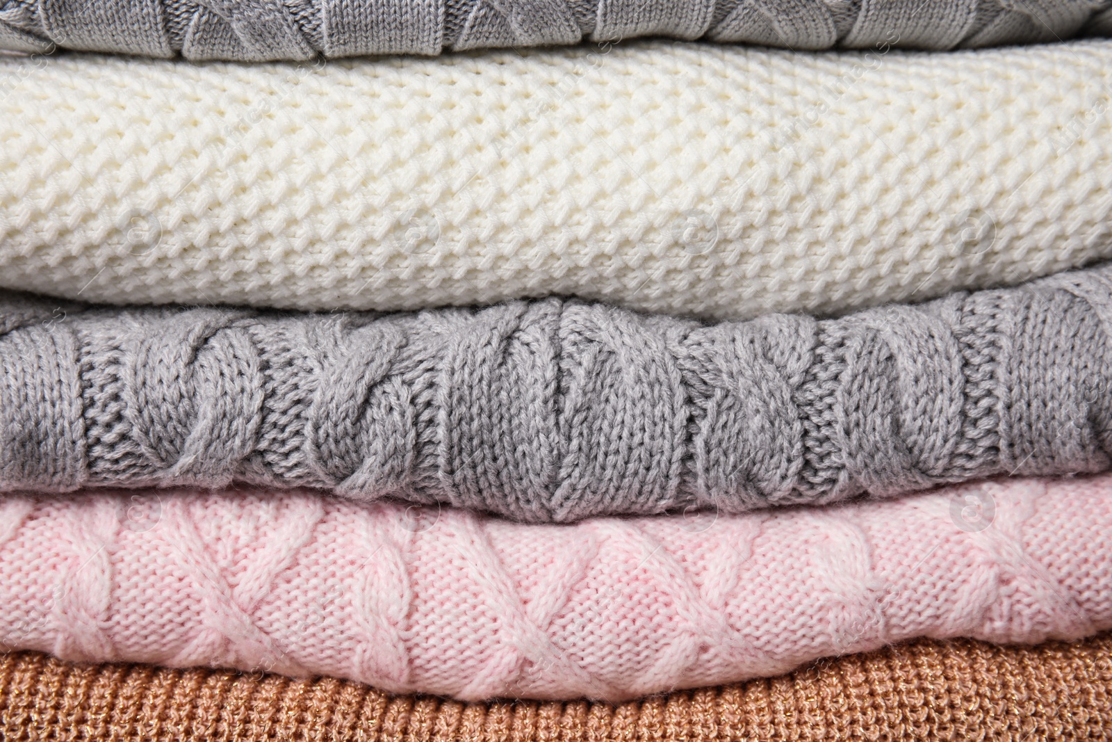 Photo of Stack of knitted clothes as background. Cozy autumn