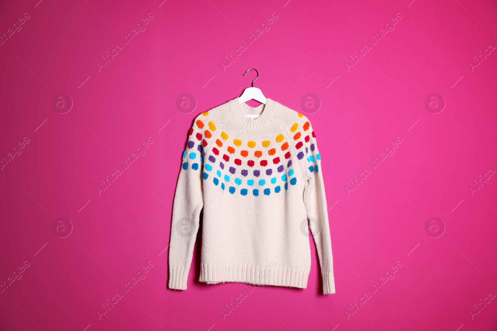 Photo of Hanger with stylish sweater on color background