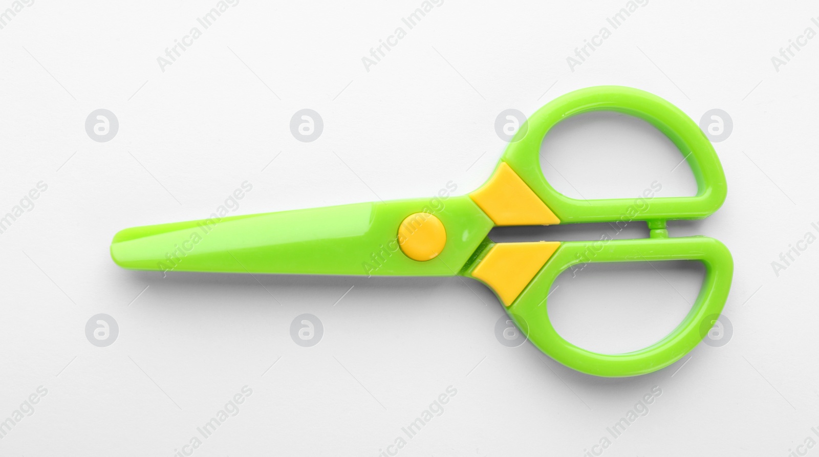 Photo of Colorful plastic scissors on white background. School stationery