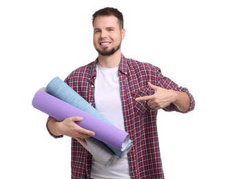 Photo of Man pointing at wallpaper rolls on white background