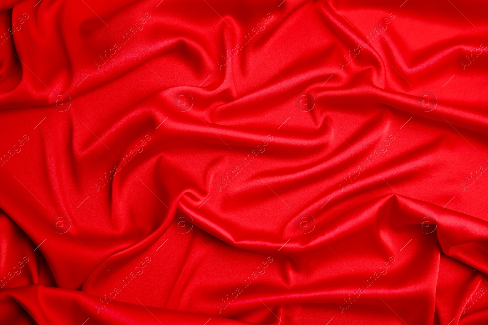 Photo of Texture of delicate red silk as background, closeup