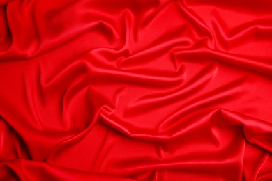 Photo of Texture of delicate red silk as background, closeup