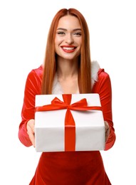 Young woman in red dress with Christmas gift on white background