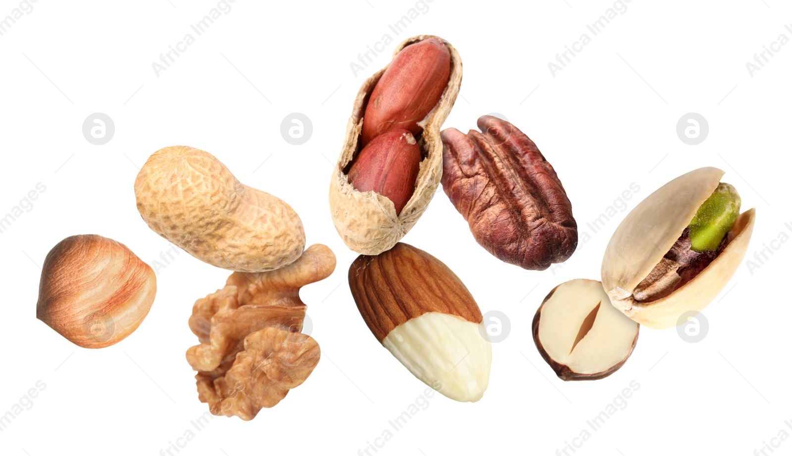 Image of Many different nuts in air on white background