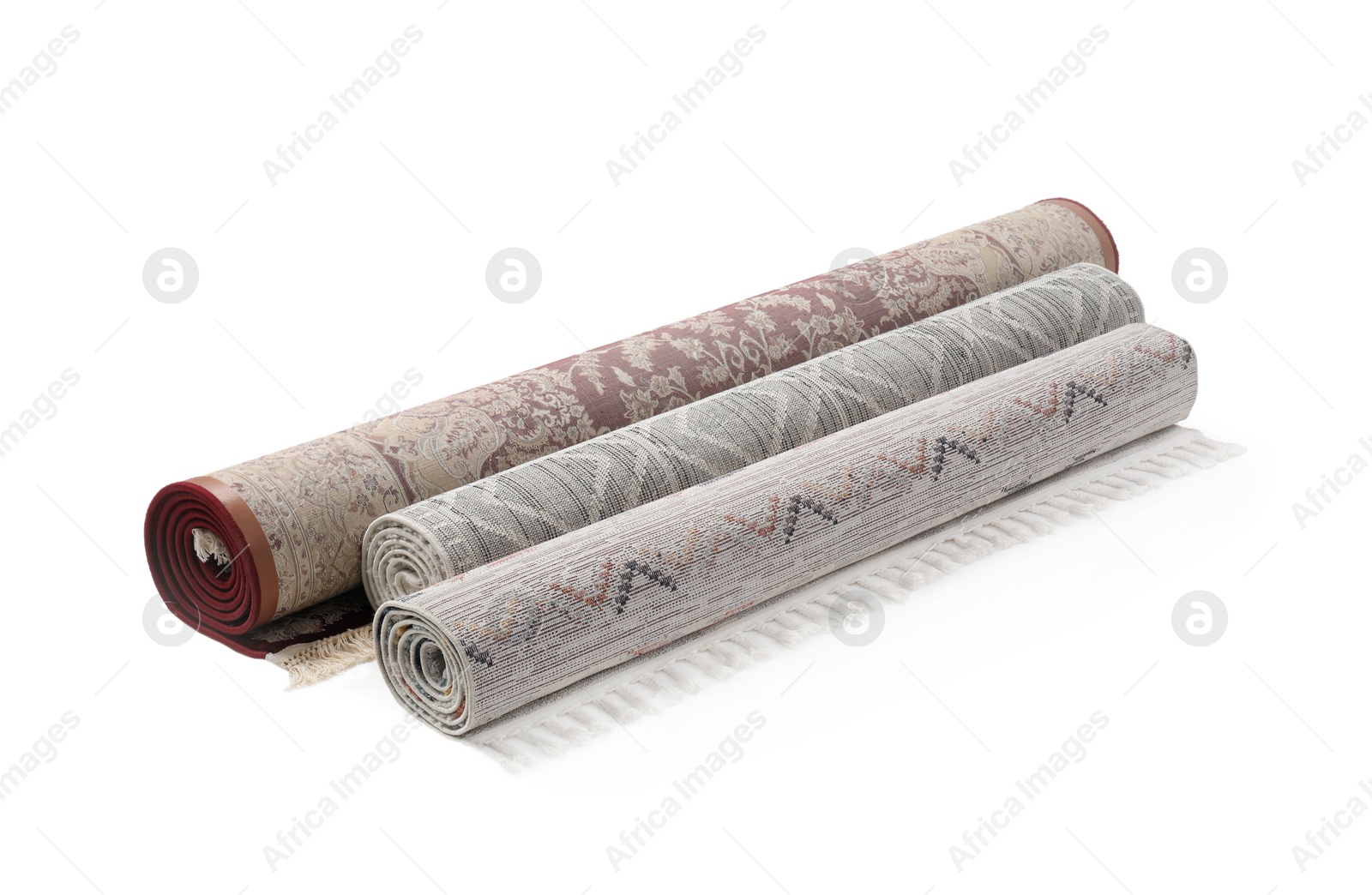 Photo of Rolled carpets on white background. Interior element