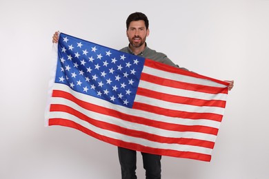 4th of July - Independence Day of USA. Happy man with American flag on white background