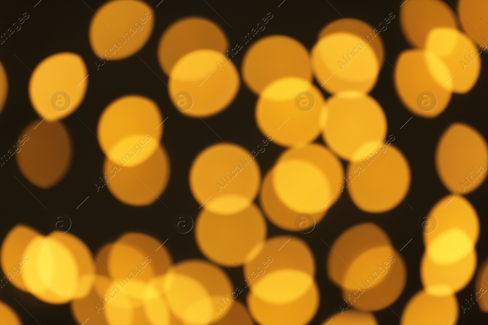 Photo of Beautiful golden lights on dark background. Bokeh effect