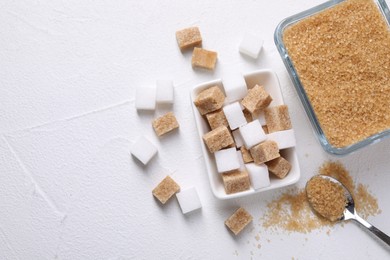 Photo of Bowls and spoon with different types of sugar on white table, flat lay. Space for text