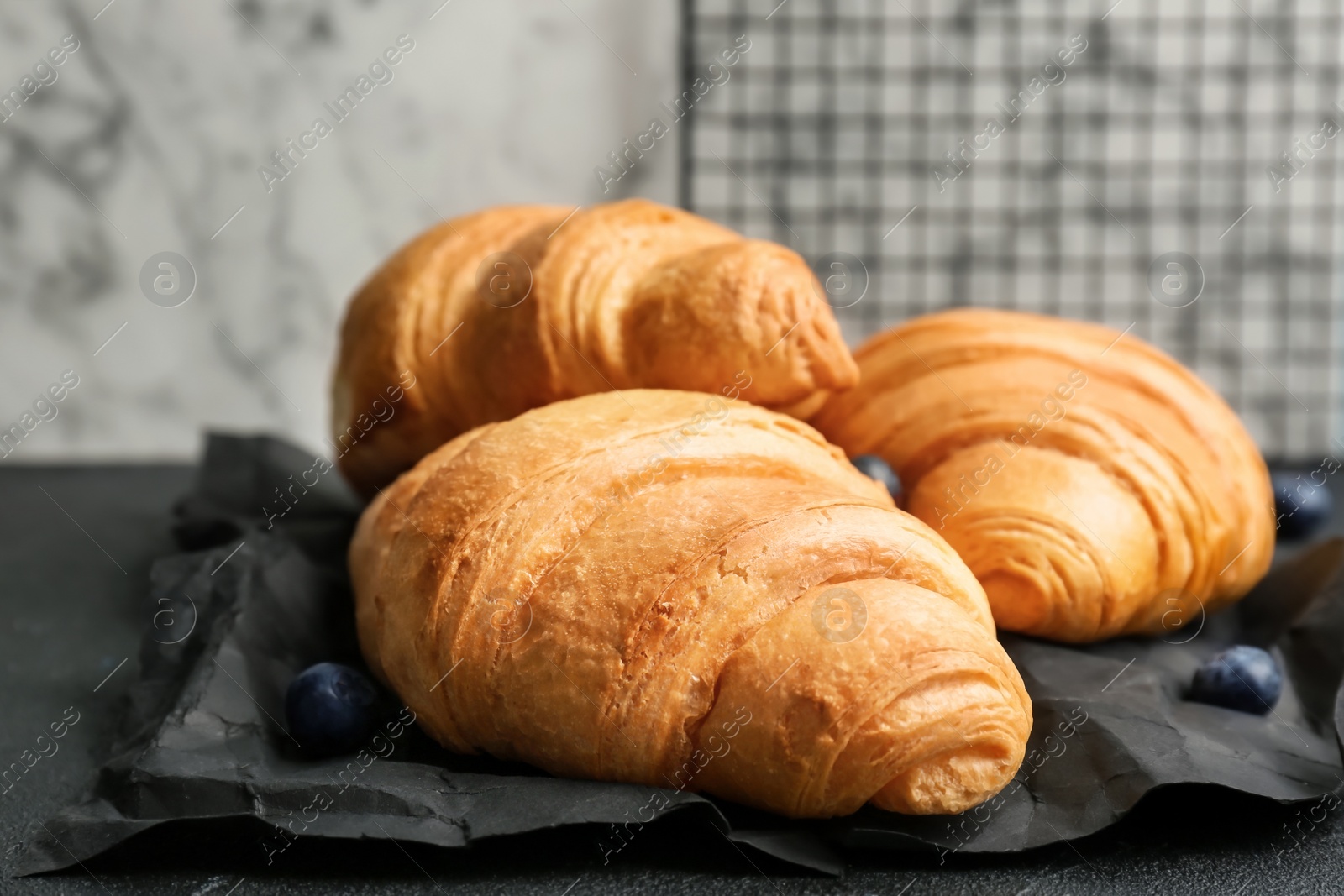 Photo of Tasty croissants on table, closeup